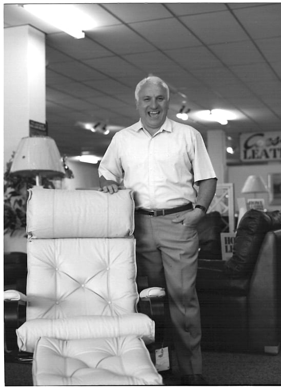 Frank Pierotti standing behind a leather recliner